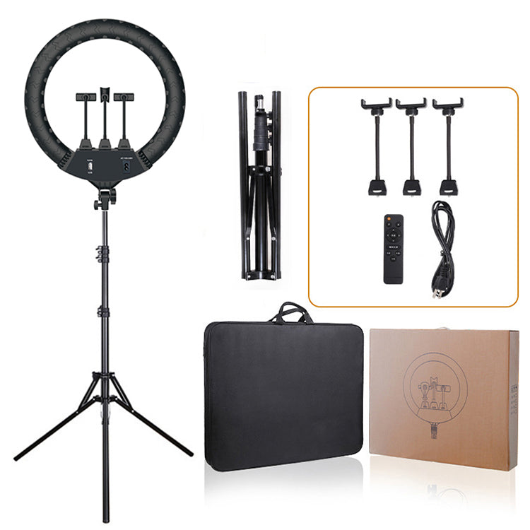 Black circular LED ring light on an adjustable tripod stand with three phone mounts, remote, cables, and carry bag.