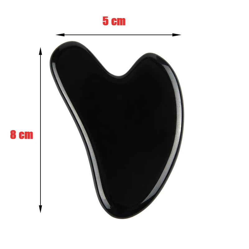 Black heart-shaped stone gua sha tool for facial massage, measuring 8cm by 5cm, on a white background.