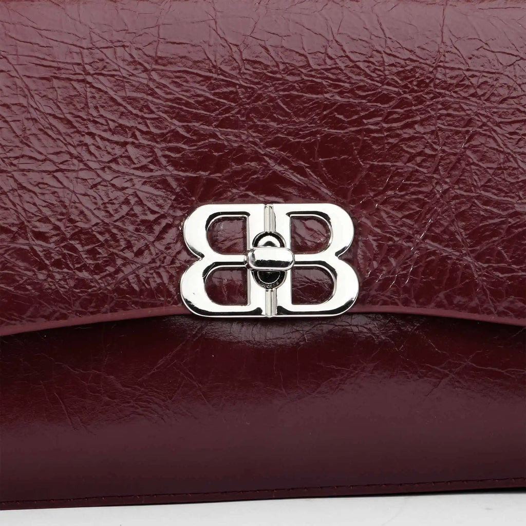 Burgundy crinkled genuine leather designer shoulder bag with a silver double-B logo clasp closure.