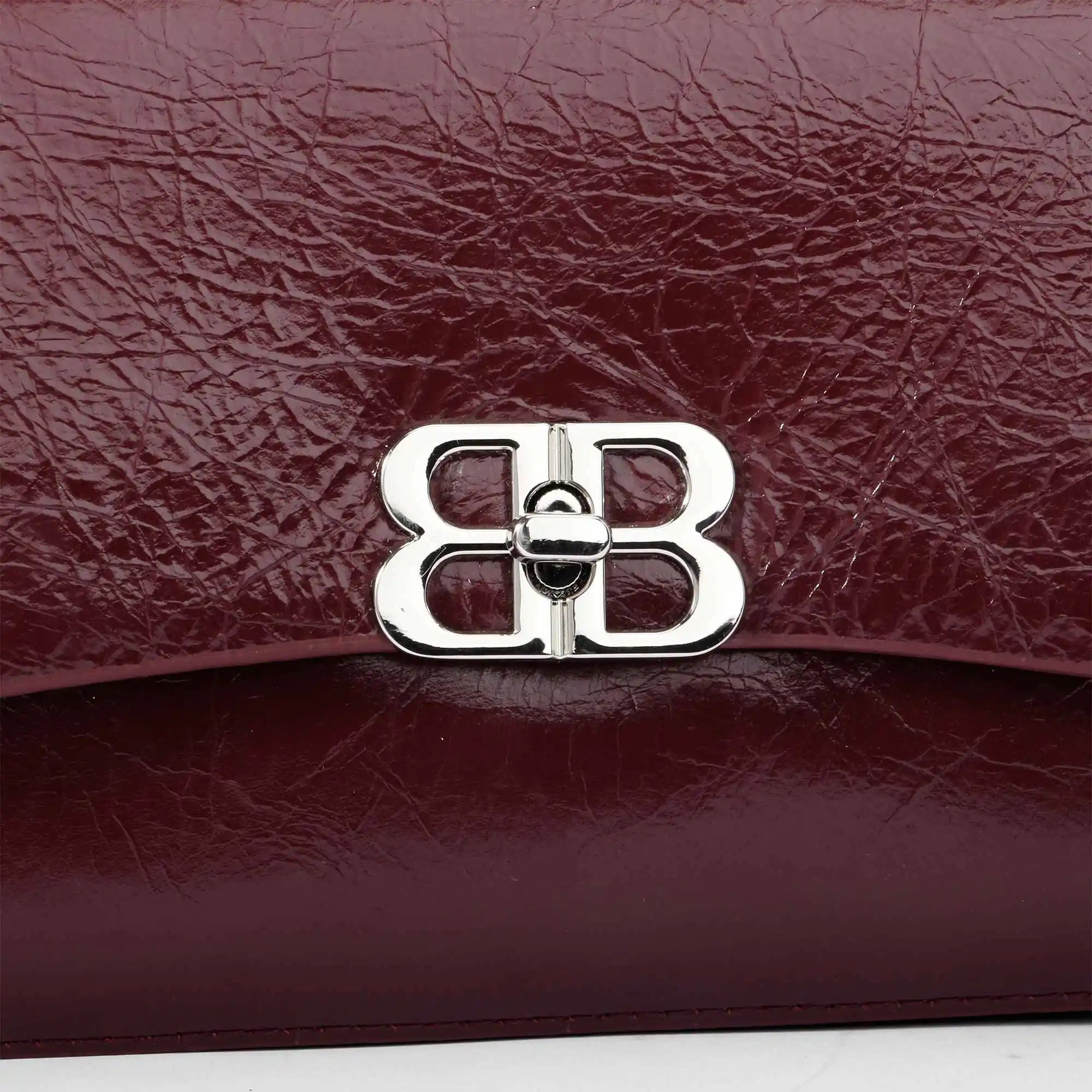 Burgundy crinkled genuine leather designer shoulder bag with a silver double-B logo clasp closure.