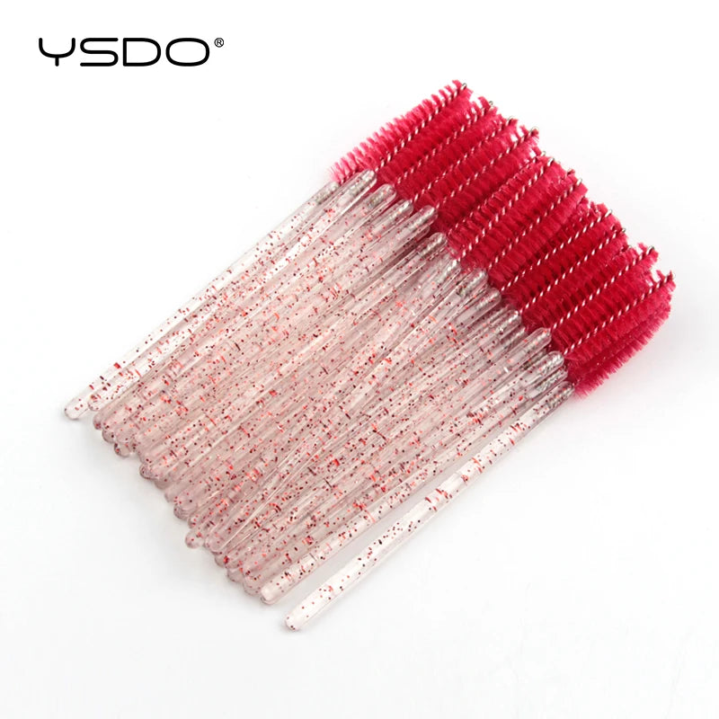 Disposable eyelash brushes with bright red bristles and clear, glitter-infused plastic handles for makeup application.