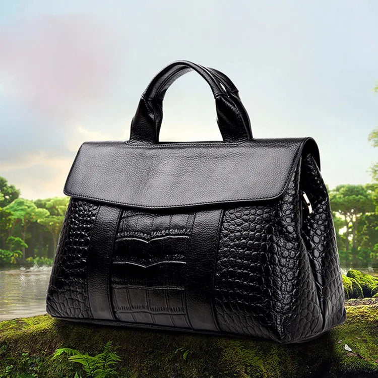 Black luxury designer handbag in genuine crocodile-embossed leather with a structured flap and top handle.