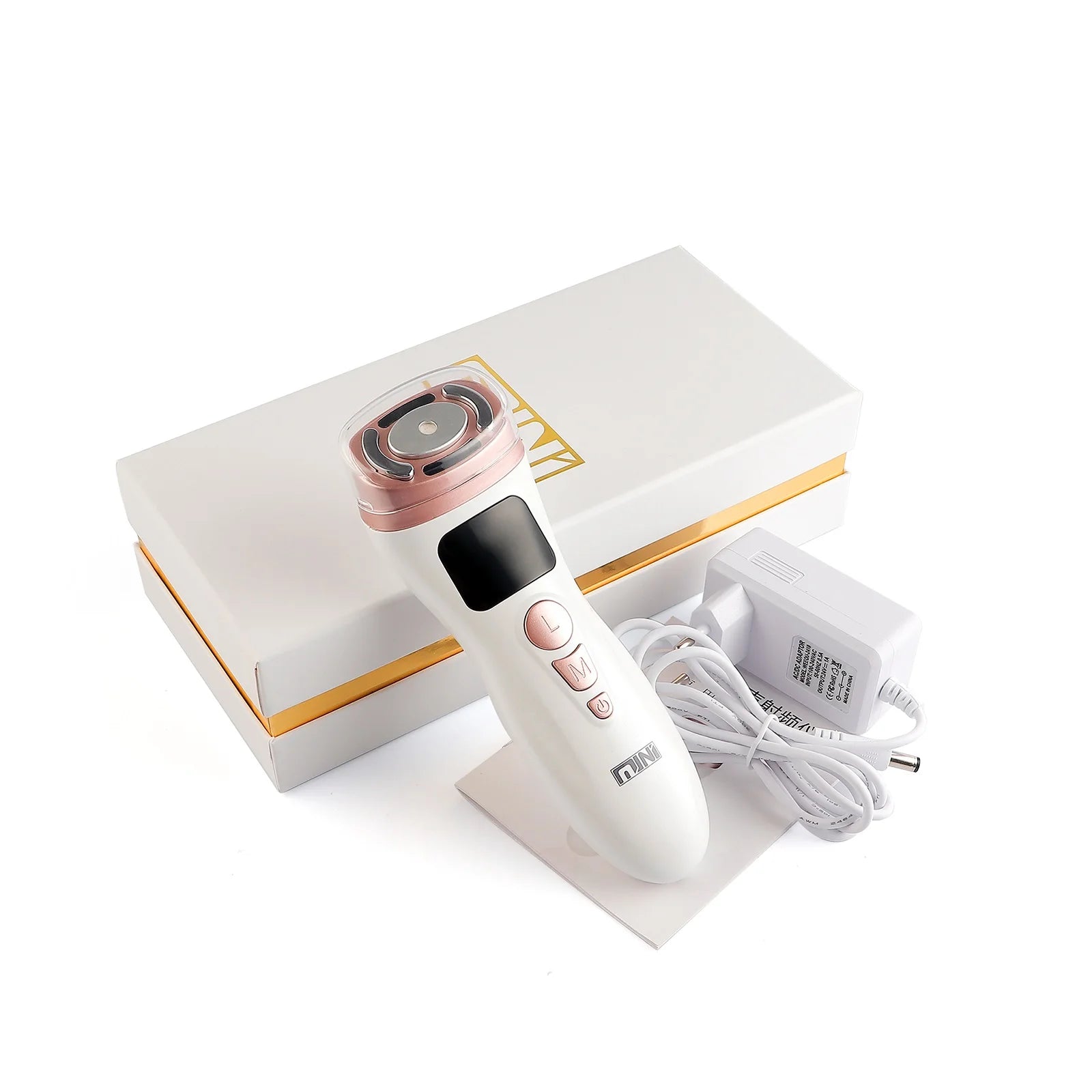 White and rose gold handheld HIFU facial tightening device with buttons, charging cable, and box on white background.