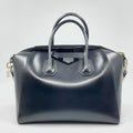 Pre-owned black leather designer handbag with gold hardware, dual top handles, and versatile crossbody strap.