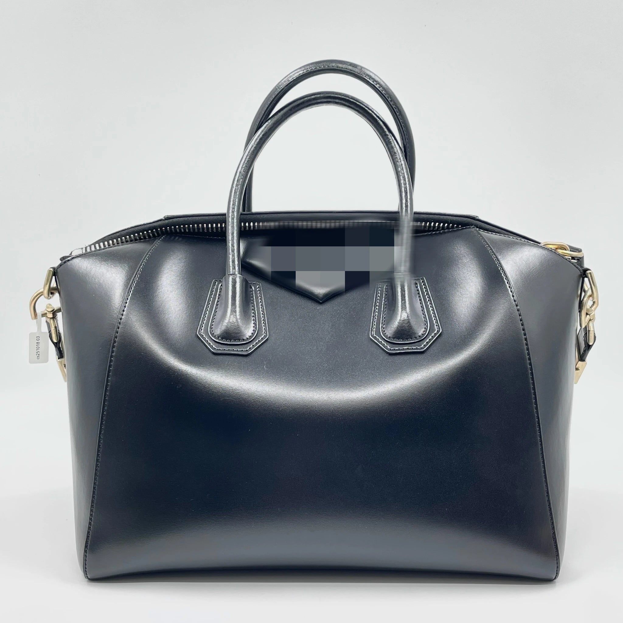 Pre-owned black leather designer handbag with gold hardware, dual top handles, and versatile crossbody strap.