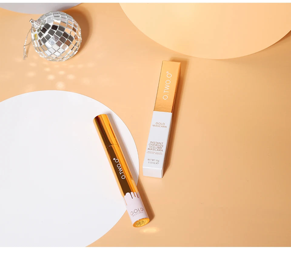 O.TWO.O gold lengthening 3D mascara tube and box on beige background, long-wear black lash beauty makeup product.