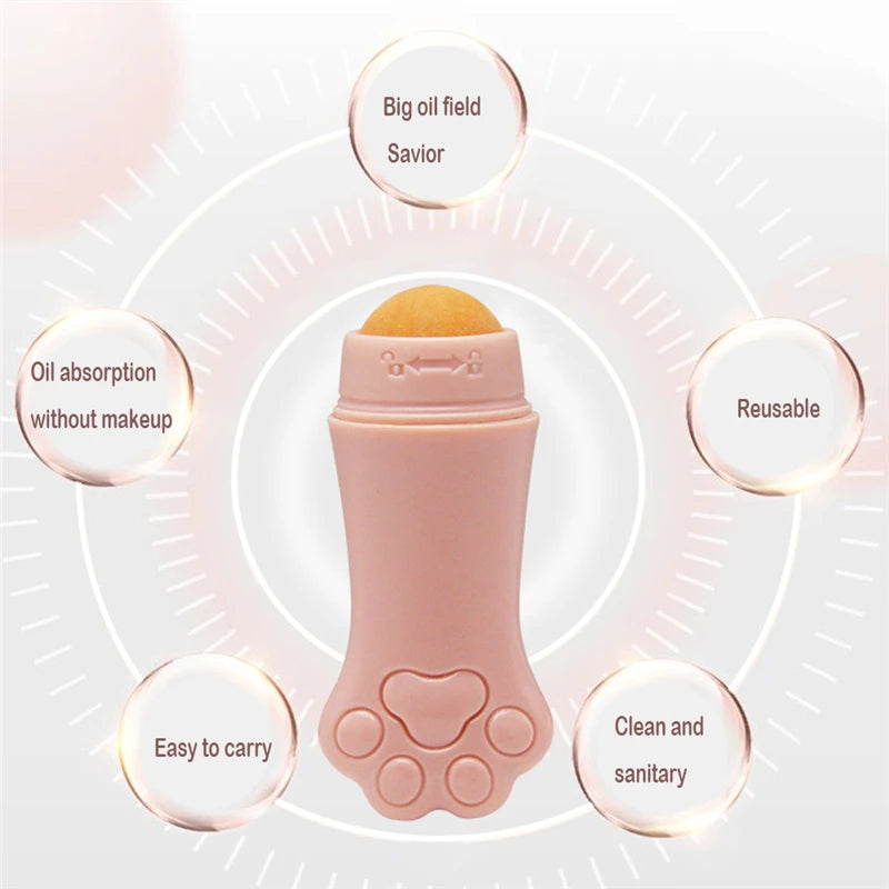 A pink, cat paw-shaped face oil absorbing roller with a round, orange volcanic stone tip.