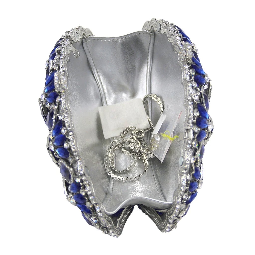 Blue crystal luxury evening clutch with silver chain strap, metallic silver interior, and ornate rhinestone crown frame.