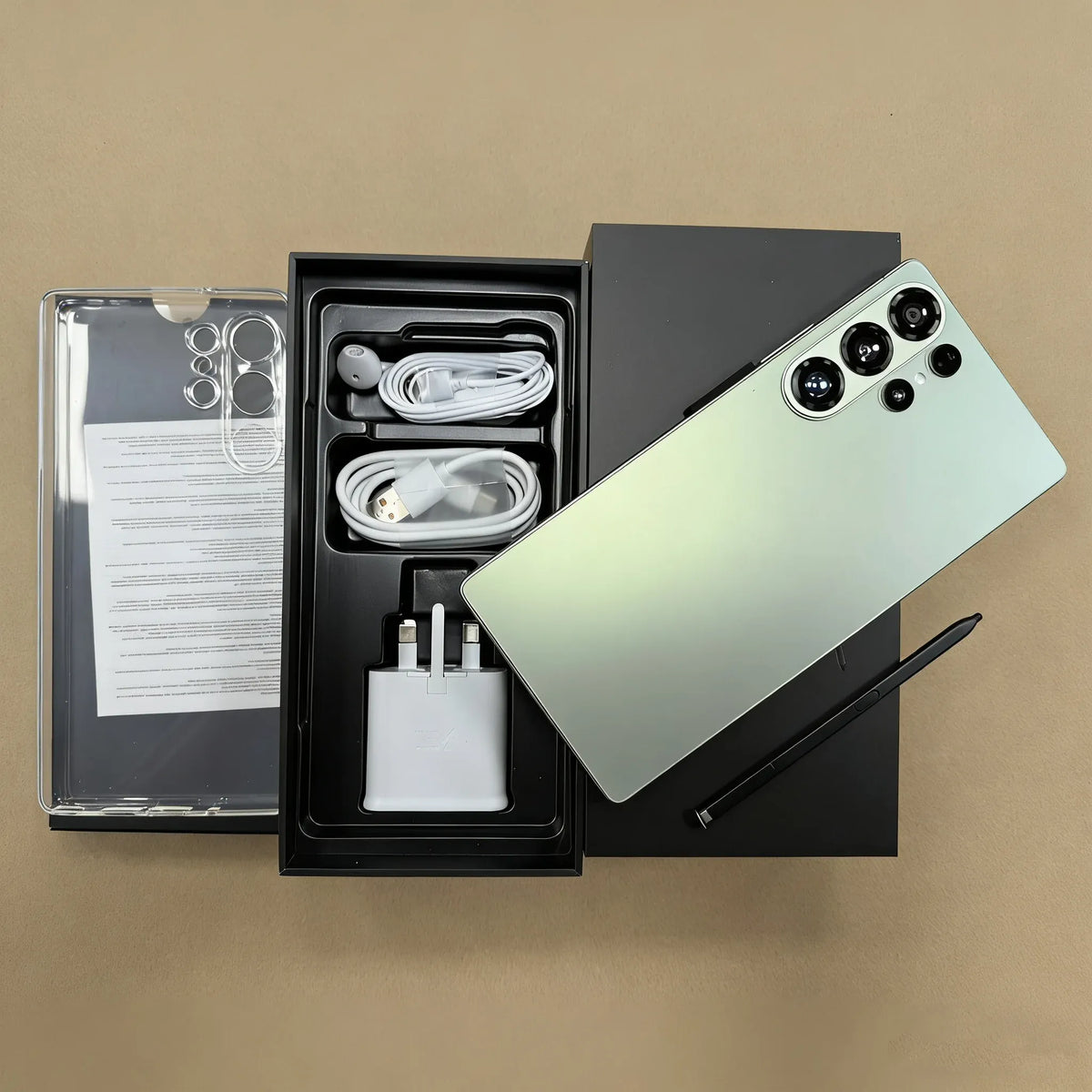 5G smartphone kit open in box: phone, charging cable, adapter, and manuals with accessories.