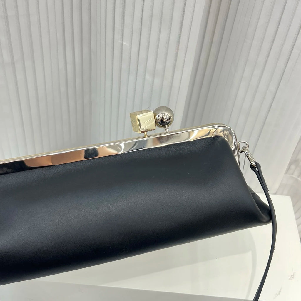 Black leather luxury designer shoulder bag with silver frame and unique cube and sphere clip clasp closure.