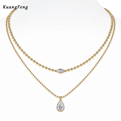 Gold-tone stacked moissanite pendant necklace with teardrop centerpiece and two chains