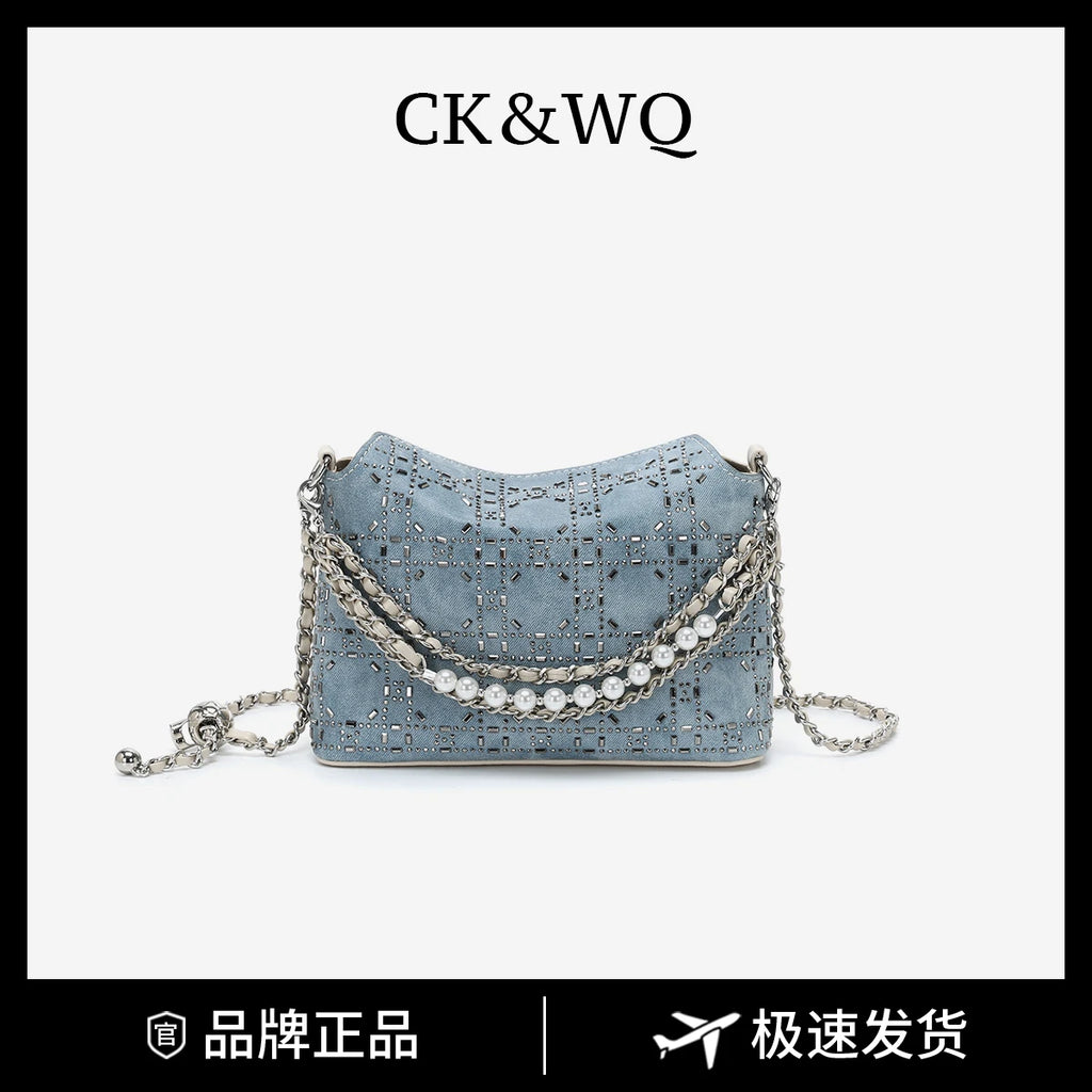 Blue denim designer hobo handbag with rhinestone grid pattern, pearl-accented chain strap, and adjustable silver hardware.