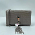 Luxury elephant grey crocodile-embossed leather designer handbag with silver chain tassel and crossbody strap.