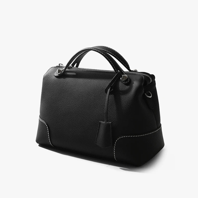 Black top-grain cowhide leather designer handbag with contrast stitching and silver-tone hardware details.