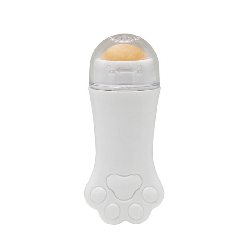 White cat paw-shaped face oil absorbing roller with a tan volcanic stone ball and clear cap.