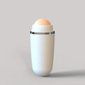 White facial oil-absorbing roller with a round, tan volcanic stone top, featuring a sleek, minimalist design.