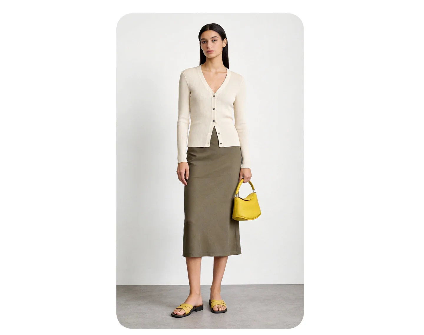 Yellow pillow-shape handbag in genuine cowhide leather with a magnetic closure and two straps. Elegant designer style.
