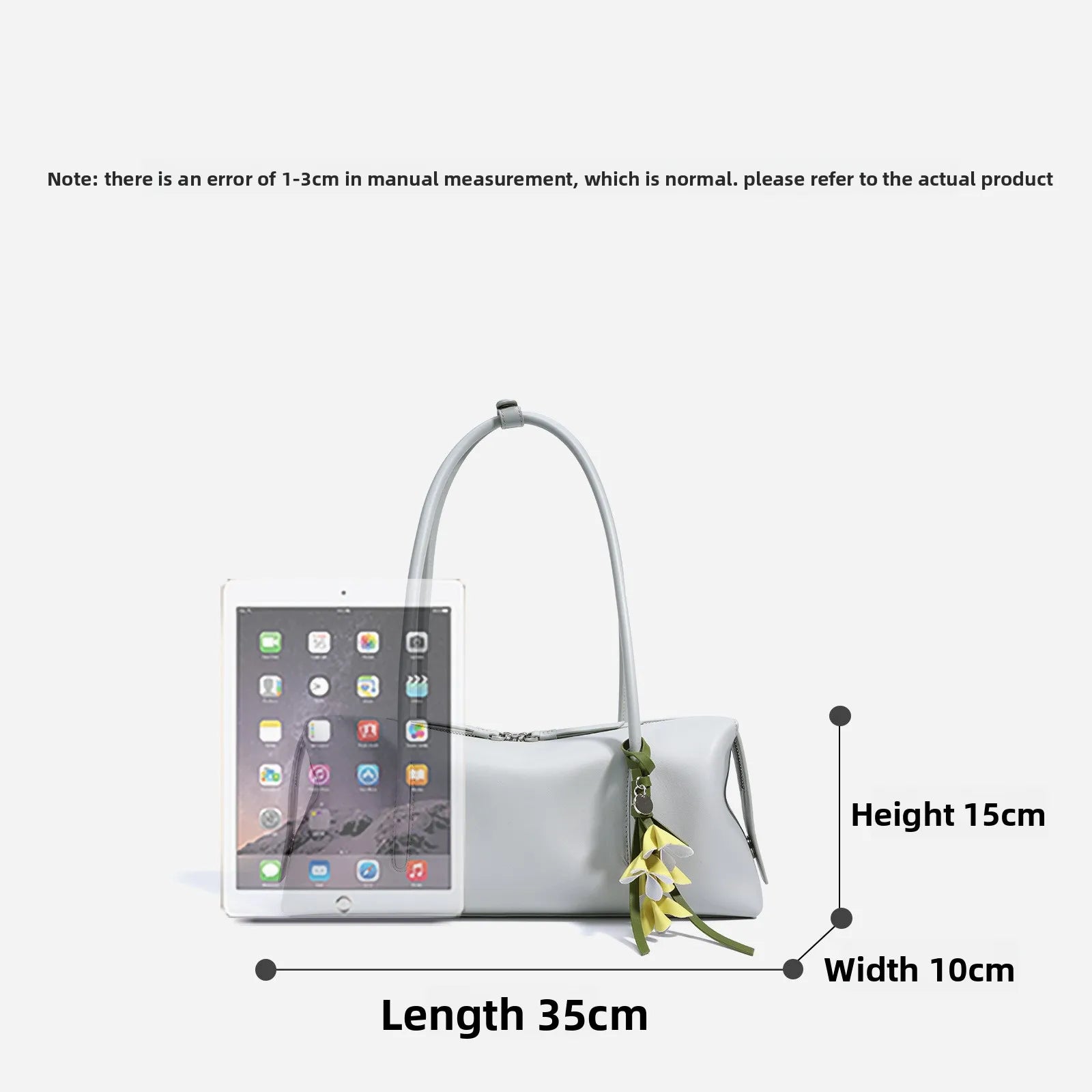Light gray genuine cowhide leather underarm shoulder bag with zipper closure and decorative floral charm.