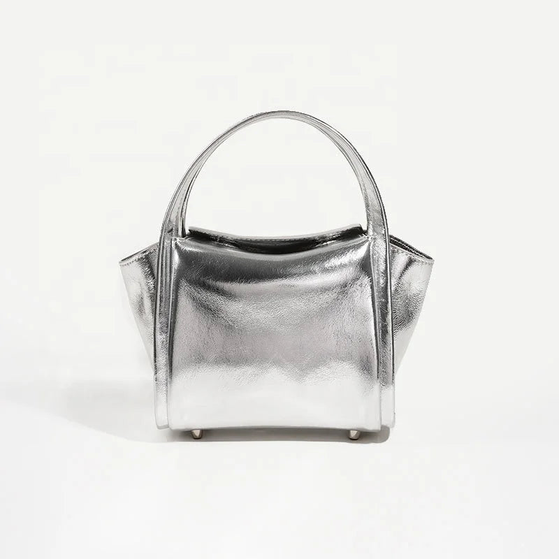 Metallic silver leather Yuanbao designer handbag with top handle, chic casual purse for women.