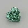Small heart-cut lab-grown diamond in vivid green on a light background
