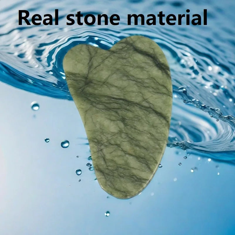 Heart-shaped green veined stone gua sha tool hovering over swirling blue water.