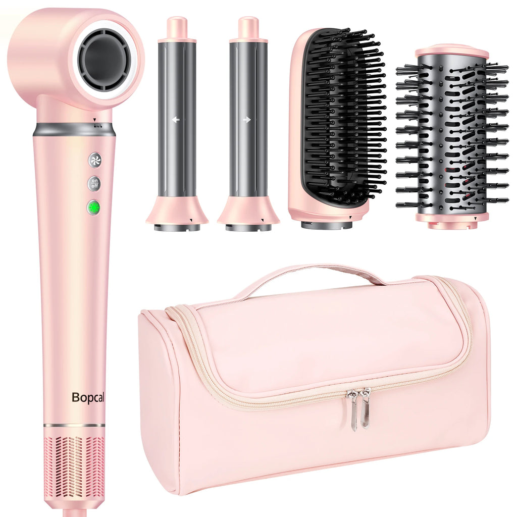 Pink 5-in-1 hot air styler set with dryer, curlers, brushes, and travel bag for professional home hair styling.