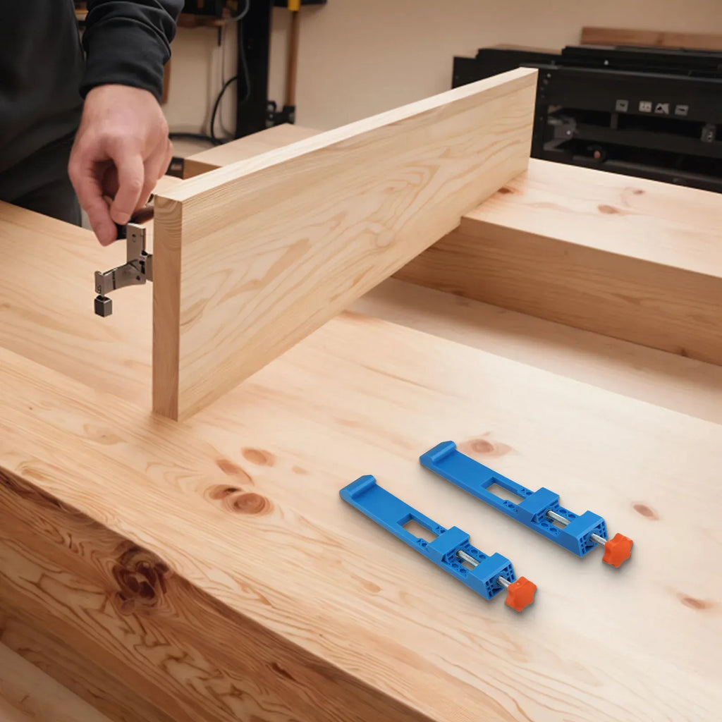 Two blue edge guide positioner clamps placed on a wooden board for cutting