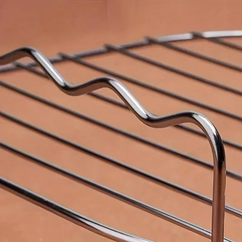 Close-up of shiny metal skewer needles with curved loops for gripping food