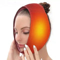 Woman wearing a red-to-orange gradient adjustable heated jaw wrap for oral surgery relief.