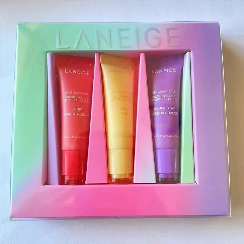 Laneige Lip Glowy Balm set in Berry, Vanilla, and Gummy Bear scents in a hydrating, colorful gradient gift box.