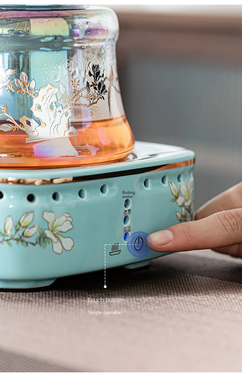 Light blue floral electric glass tea maker with touch button control base for boiling and brewing tea.