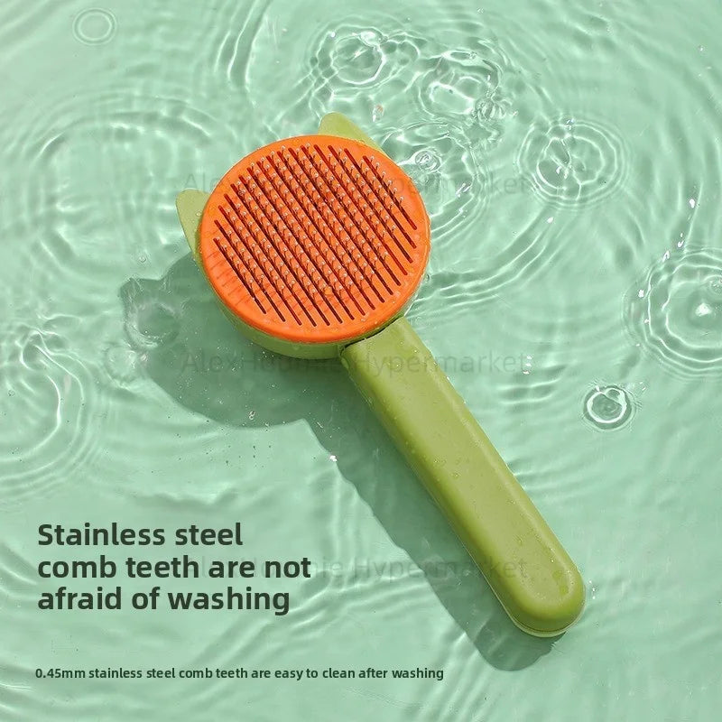 Green and orange cat grooming brush with stainless steel teeth for easy pet hair removal and washing.