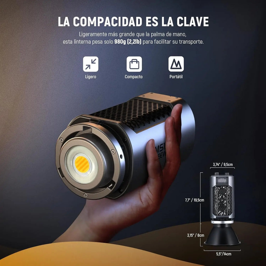 Compact LED flashlight held in hand, featuring a silver cylindrical metal body, honeycomb cooling, and a 7.7-inch build.