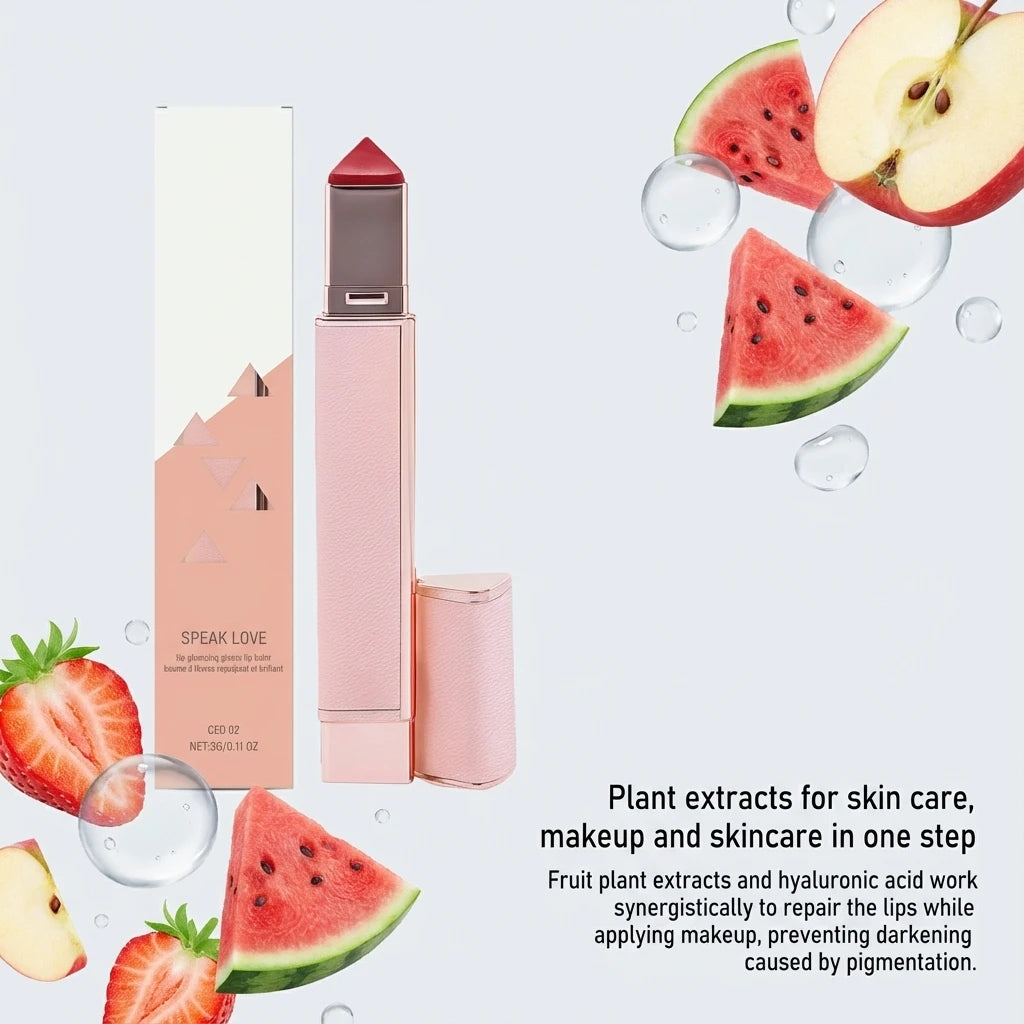 Glossy hydrating lip balm stick in rose gold case with red tip, surrounded by fresh fruit for a plump, moisturized look.