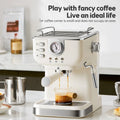 Cream retro espresso machine with pressure gauge, steam wand, and portafilter brewing coffee on a kitchen counter.