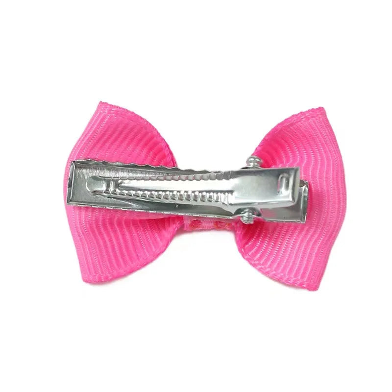 Pink ribbon dog hair bow with metal clip for cute pet grooming and easy styling for small dogs and cats.