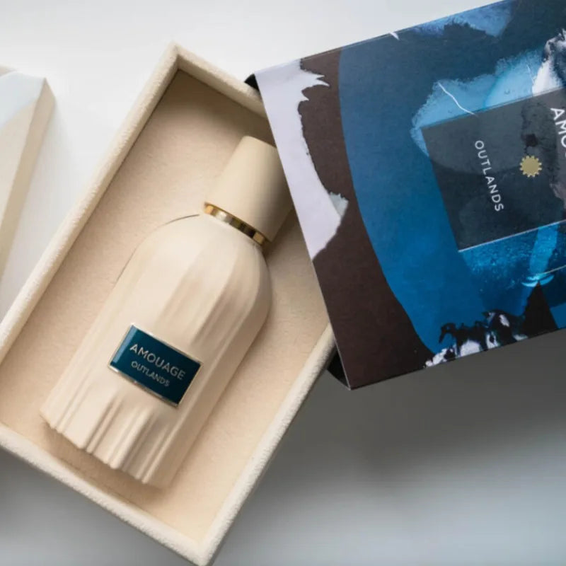 Amouage Outlands 100ml EDP: Unisex woody oriental perfume in a ribbed cream bottle with elegant, long-lasting scent.