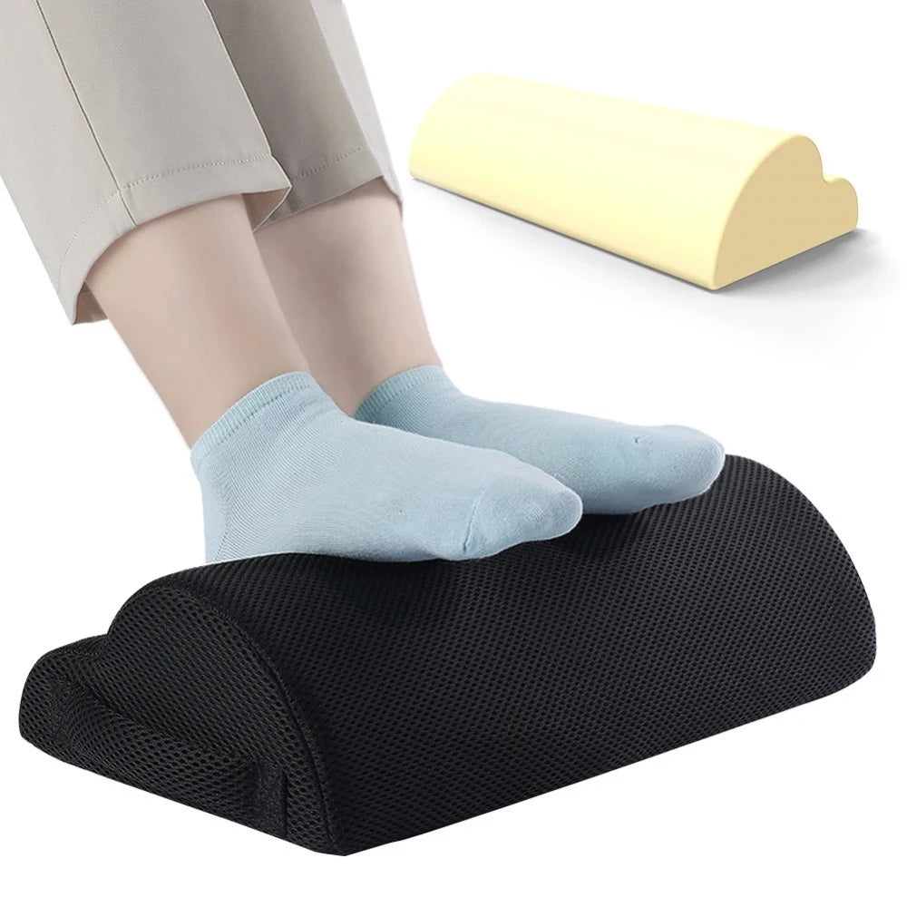 Ergonomic black mesh memory foam under desk foot rest with removable cover supporting feet while working.