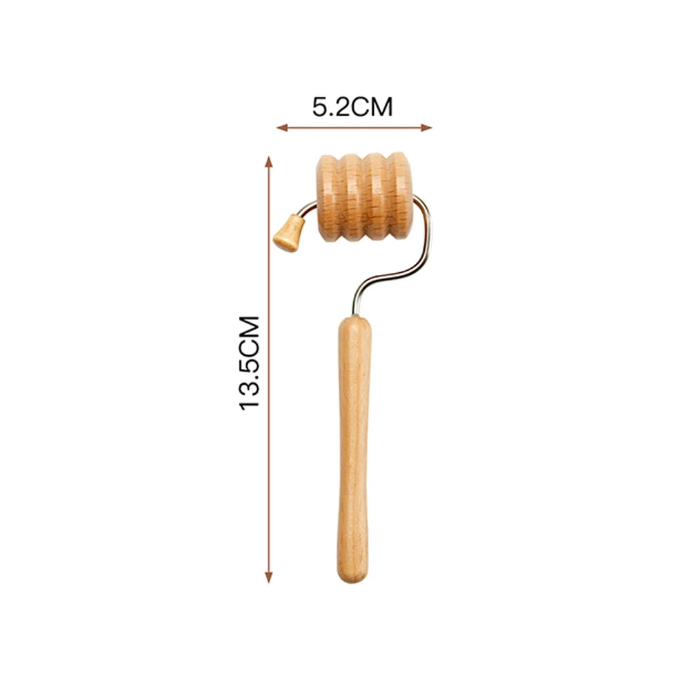 Wooden face massager with a ribbed rolling wheel, a long handle, and dimension markers indicating 5.2cm and 13.5cm.