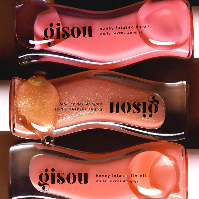 Gisou Honey Infused Lip Oil collection in glazed plum and shimmering shades for glossy, plumping lip care.
