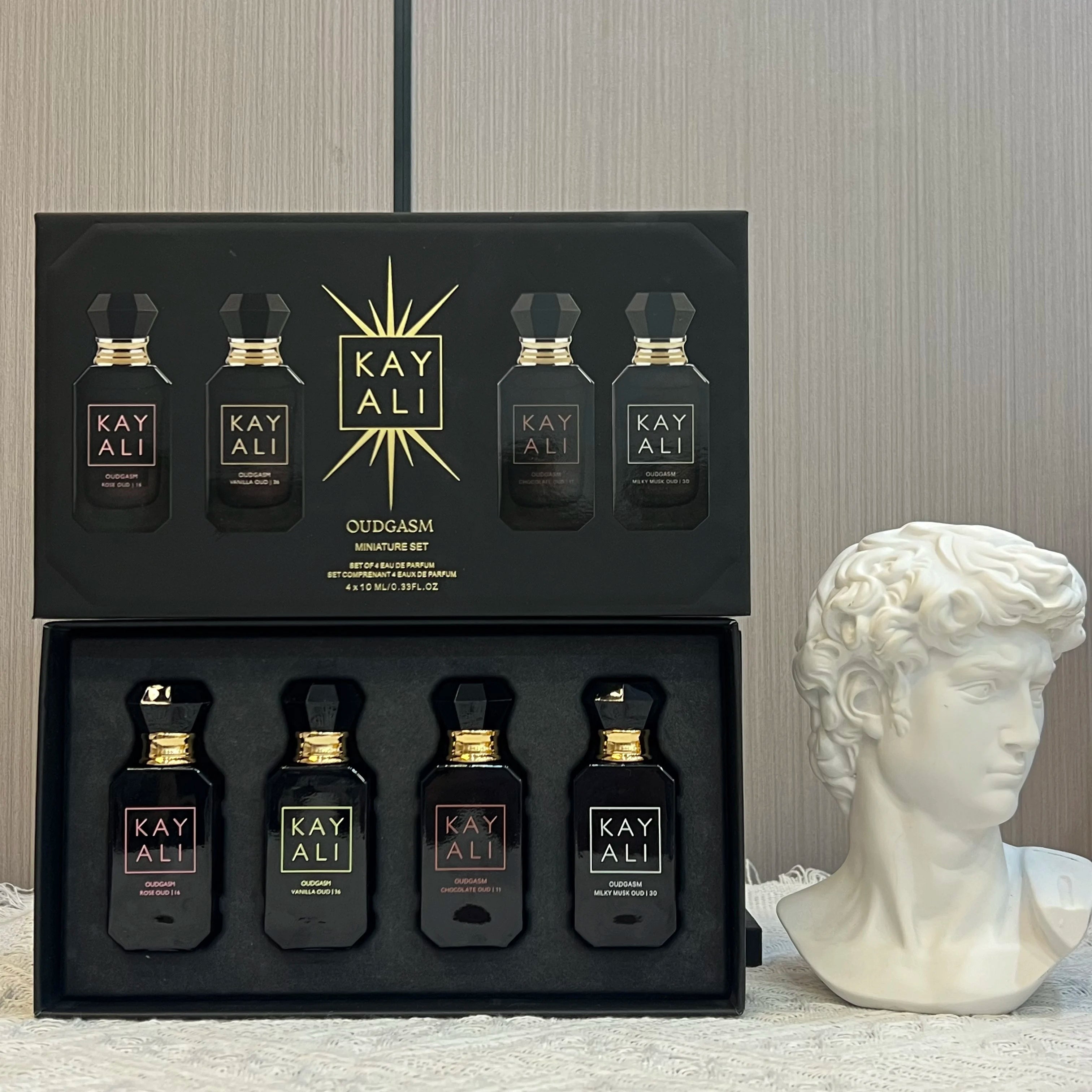 KAYALI Oudgasm EDP perfume gift set for women featuring 4 floral, musk, and oud miniature bottles in a black box.