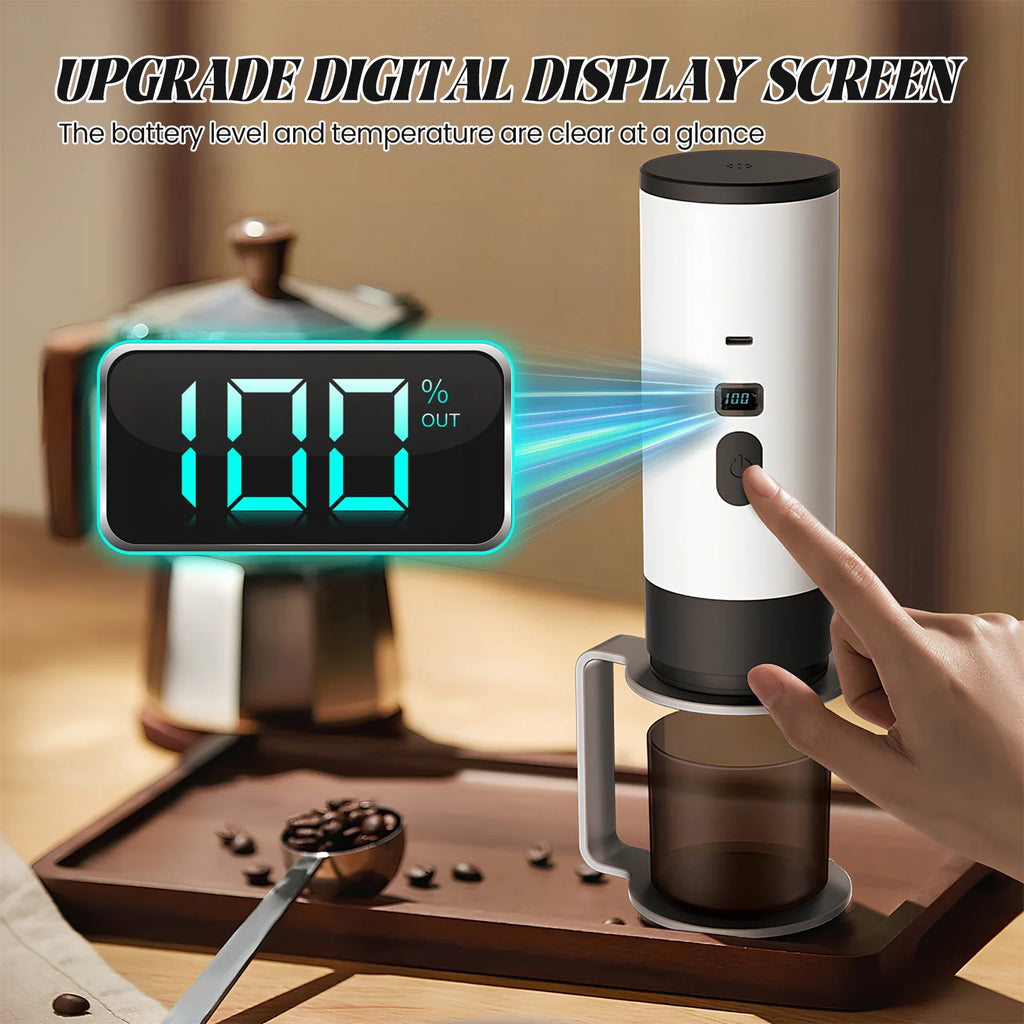 White portable electric coffee maker with digital display screen showing battery level, placed on a tray.