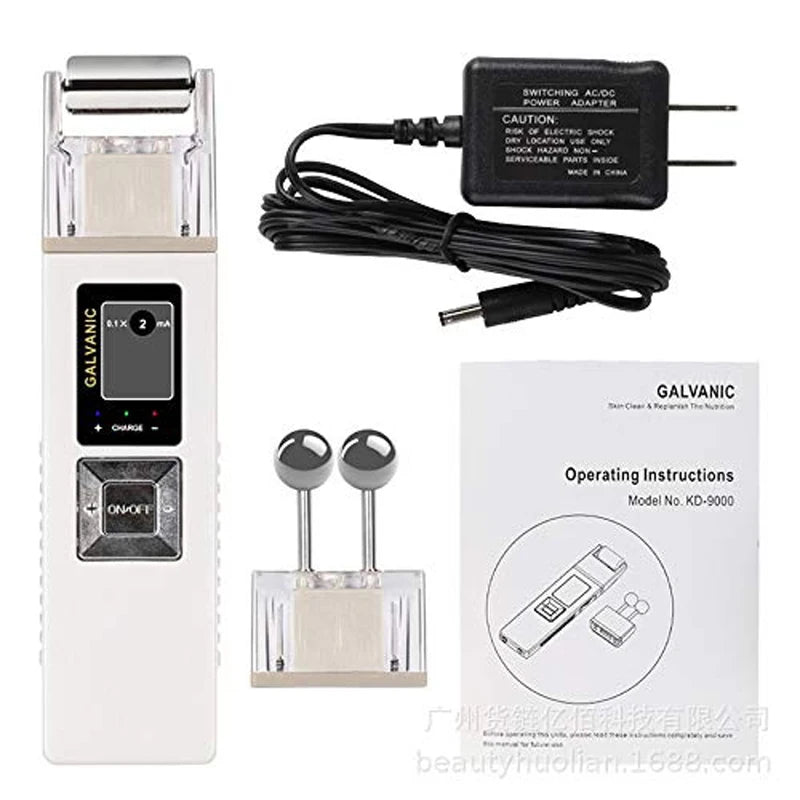 White galvanic facial device with two interchangeable metal roller and ball heads, power adapter, and instructions.