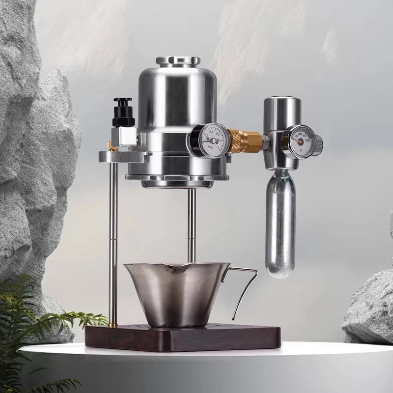 Stainless steel manual espresso maker with pressure gauges, CO2 cartridge, and wooden base for specialty coffee brewing.