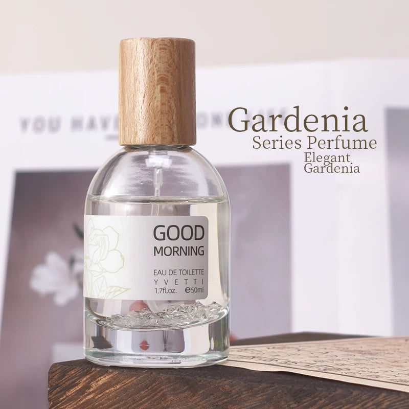 Glass perfume bottle with wooden cap, clear liquid, and floral label for Pure Gardenia niche fresh floral fragrance.