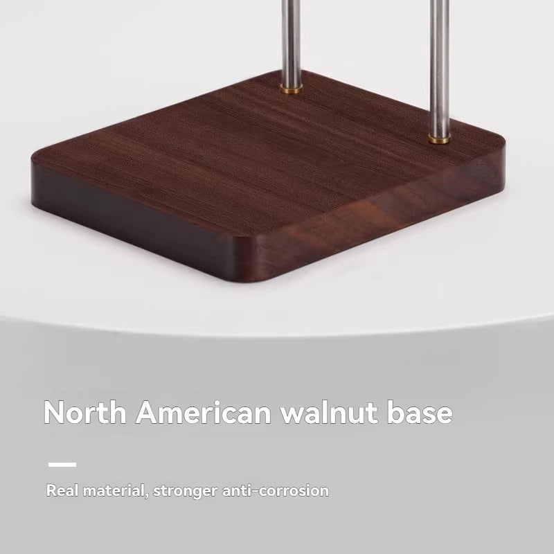 Coffee dripper stand with North American walnut wooden base and stainless steel metal rods on a white background.