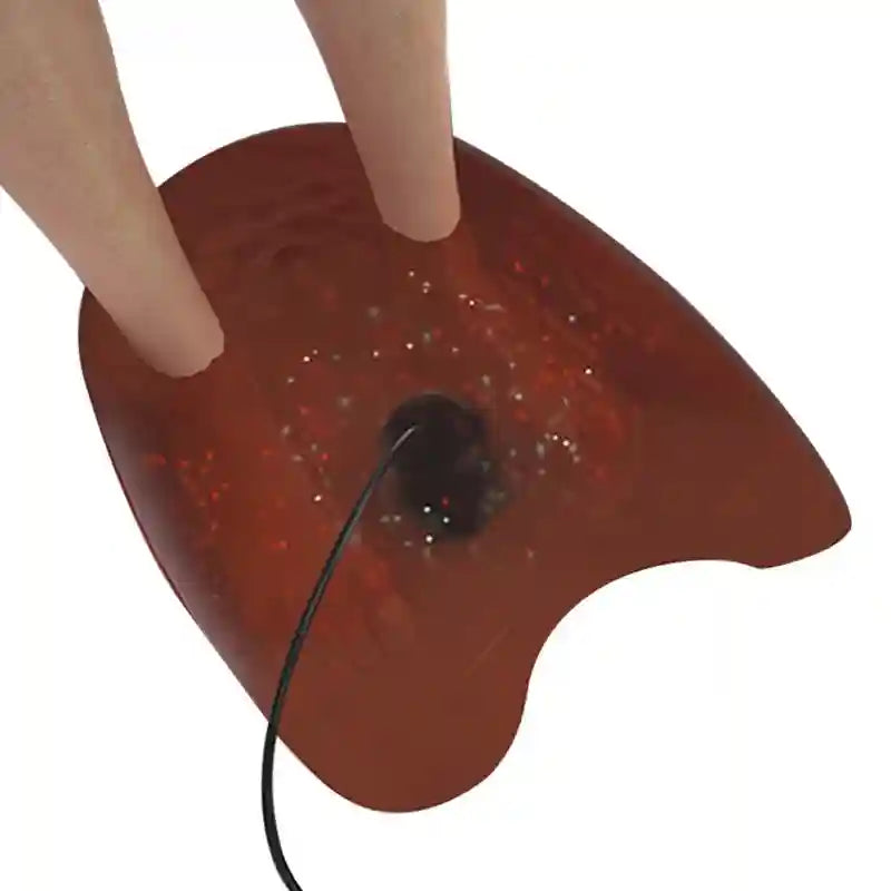Round ionic detox foot bath array head with black cable in dark red water for spa pedicure health massager device.