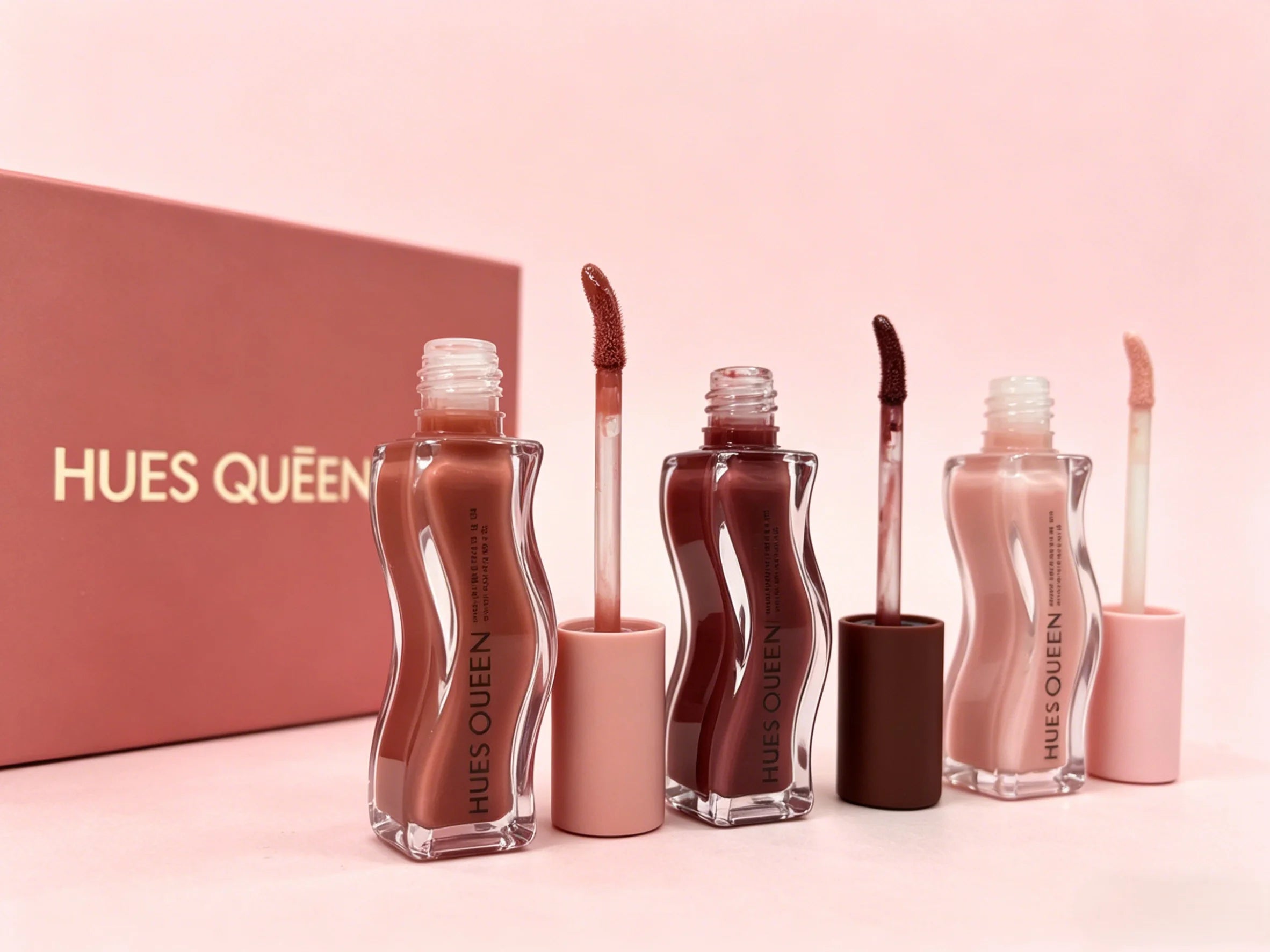 Hues Queen 3-piece moisturizing lip gloss set in nude, deep rose, and berry tints with a glossy, hydrating finish.