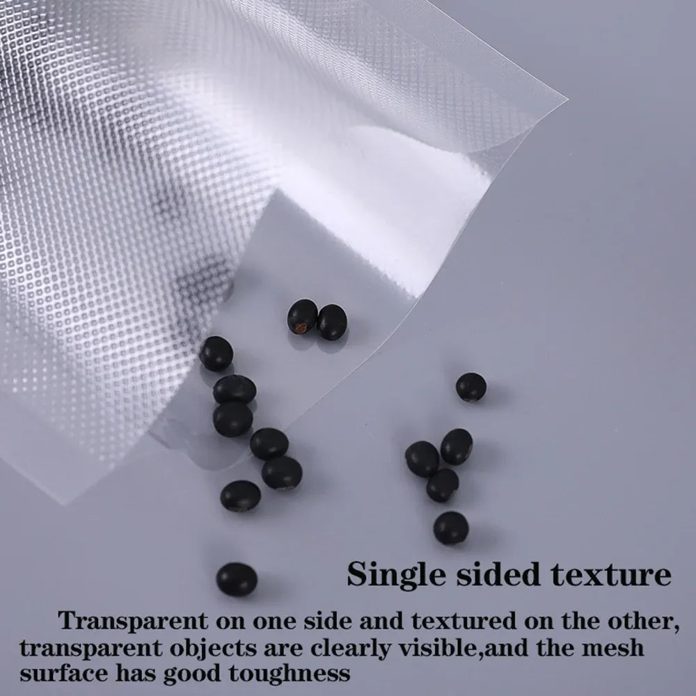 Clear vacuum sealer bag roll material with single-sided textured surface