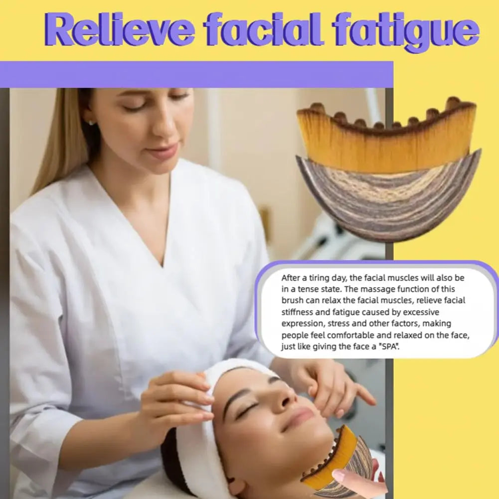Curved facial massage brush with soft tan bristles and a grey textured handle, shown in use on a person's jawline.